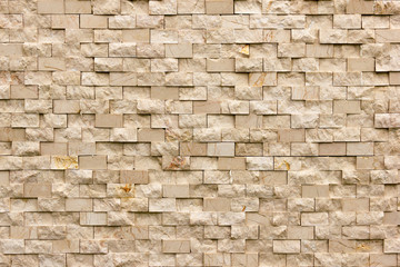 Rectangular marble tiles in beige color. Beige marble wall texture Wallpaper background.