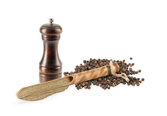 ground black pepper in a wooden spoon on a white background