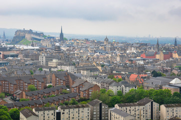 Naklejka na ściany i meble Cityscape of the City of Edinburgh and its famous Castle on a typical foggy summer afternoon
