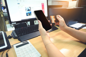 businesswoman hand using smart phone, tablet payments and holding credit card online shopping, omni channel, digital tablet docking keyboard computer at office in sun light