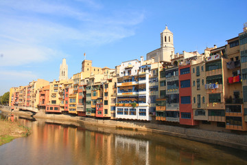 The amazing colorful houses along the river Onyar and the Cathedral of Saint Mary in the gorgeous city of Girona, Catalonia, Spain.