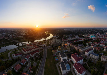 The embankment, the Neman river and the Old bridge in Grodno. Autumn ,evening, the city in the sunshine against a background of dark clouds.