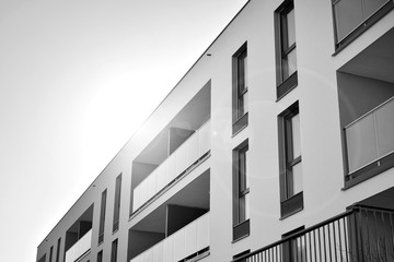 Fototapeta premium Detail of modern residential flat apartment building exterior. Fragment of new luxury house and home complex. Black and white.