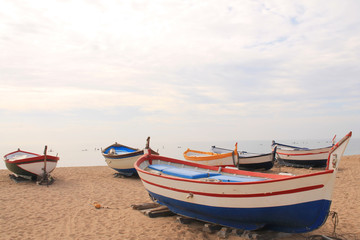 Naklejka na ściany i meble Traditionals wooden boats in Callela beach, a seaside city on the Costa del Maresme, in the northeast of Barcelona, in Catalonia, Spain