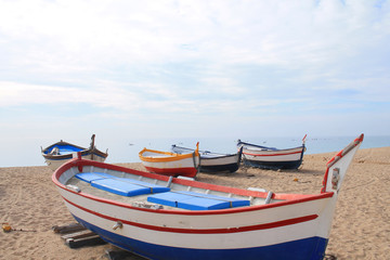 Naklejka na ściany i meble Traditionals wooden boats in Callela beach, a seaside city on the Costa del Maresme, in the northeast of Barcelona, in Catalonia, Spain