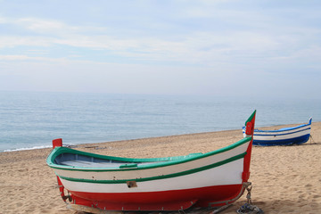 Fototapeta premium Traditionals wooden boats in Callela beach, a seaside city on the Costa del Maresme, in the northeast of Barcelona, in Catalonia, Spain