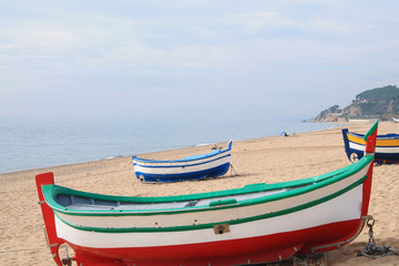 Fototapeta premium Traditionals wooden boats in Callela beach, a seaside city on the Costa del Maresme, in the northeast of Barcelona, in Catalonia, Spain
