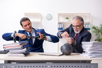 Two male employees unhappy with excessive work