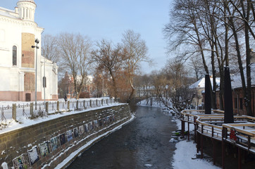 Fototapeta na wymiar Vilnius bohemian and artistic district next to Vilnia River. Beautiful winter day in the capital of Lithuania.