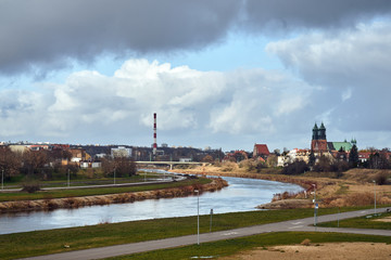 Fototapeta premium Urban landscape with river Warta and the cathedral towers in Poznan.