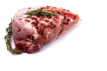 pork tenderloin in one piece with rosemary sprigs on a white isolated background