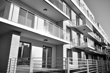 Detail of modern residential flat apartment building exterior. Fragment of new luxury house and home complex. Black and white.