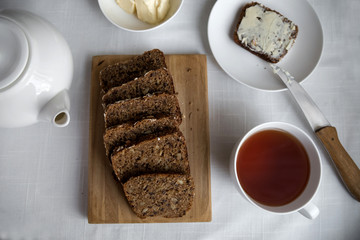 Whole grain bread on a white plate, healthy breakfast.