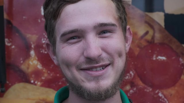 Young white male, full facial, face only, smiling, beard, dimples, talking