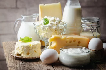 Foto op Plexiglas Fresh dairy products, milk, cottage cheese, eggs, yogurt, sour cream and butter on wooden table © petrrgoskov