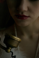 Close up portrait selective focus view of  young adult female dressed in 1920s fashion style...