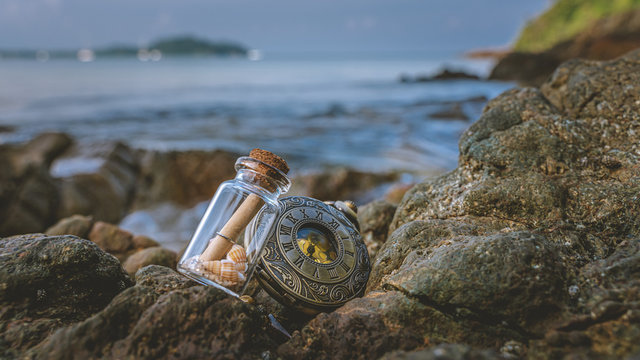 SOS Message In Bottle And Watch On Sea Stone