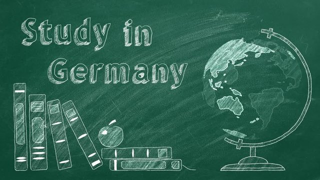 Lettering "Study in Germany", rotating globe and school books are drawn with chalk on a blackboard. Study abroad concept.