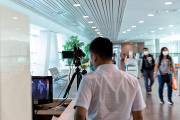 Airport medical staff detect incoming passengers body temperature with thermal camera equipment prevent the spread of the coronavirus outbreaks