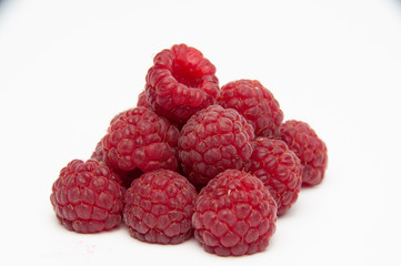 Red raspberries, smooth pyramid, three by three, front view on a white background