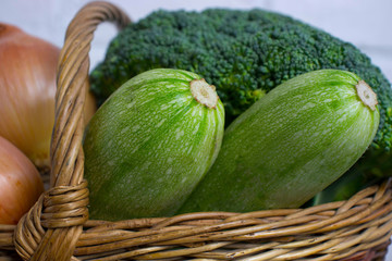 Different vegetables in basket isolated on white