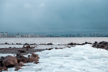 Natural background of ice. Large chunks of ice underfoot. Ice on the Bay.