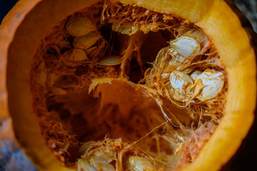 Top view looking into an open pumpkin with seeds