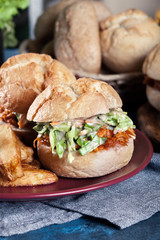 Pulled chicken sandwich with salad and bbq sauce