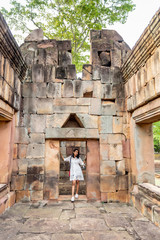 Happiness Means Everything, Young Asian Woman Smile at Prasat Muangtam Castle in Buriram Province, Thailand.
