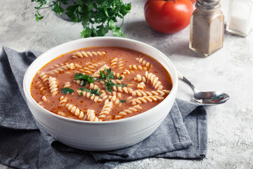 Tomato soup with fusilli pasta in the bowl