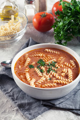 Tomato soup with fusilli pasta in the bowl