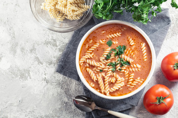 Tomato soup with fusilli pasta in the bowl