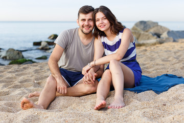 Fototapeta premium Happy loving couple sitting and hugging
