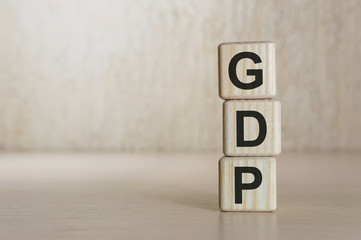 GDP word written on wood block. GDP text on wooden table for your desing, concept.