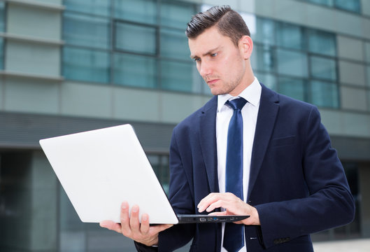 Male is examining project on a laptop