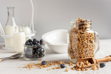 Homemade Ready breakfast granola, muesli with a fresh ripe blueberry and milk. Close-up, useful product, background.