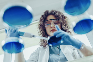 Young scientist working at the lab. Young female scientist doing some research.