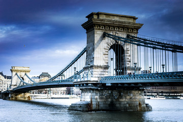 The Széchenyi Chain Bridge is a chain bridge that spans the River Danube between Buda and Pest, the western and eastern sides of Budapest, the capital of Hungary.