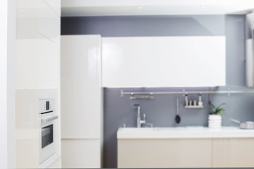 Fototapeta na wymiar white modern kitchen in blur