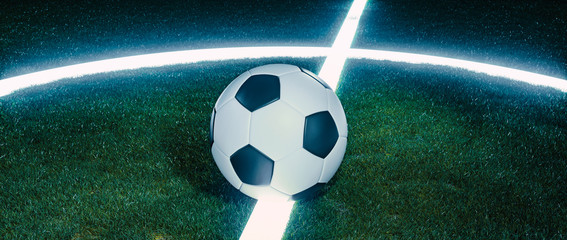 Soccer ball on glowing lines on a field at night