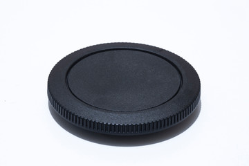 Camera body cap close-up. In white background.