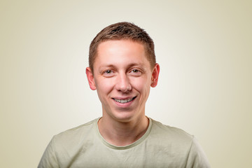 Fototapeta premium Portrait of a young pleasant man on a yellow background.