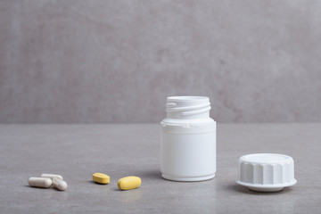 pills and bottle on white background