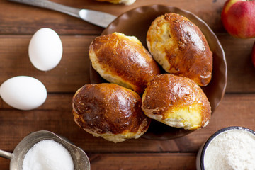 homemade apple pies, yeast pies on a wooden table with eggs and milk in the village, village pies with apple filling © Маргарита Медведева