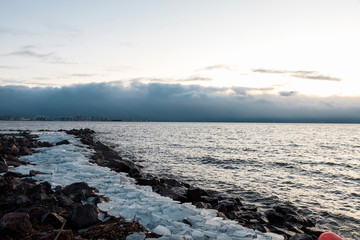 Piece of ice. Broken ice on the shore of the Gulf of Finland. Transparent ice.