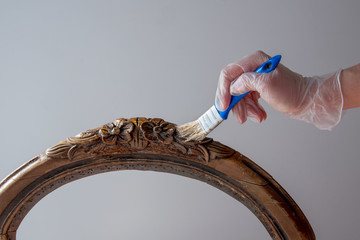 Applying with brush remover for removing from furniture the old paint and varnish with gel wood...