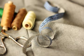 Sewing. Spools of thread on the fabric. Threads. Meter