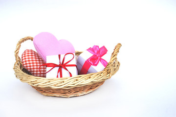 Fototapeta na wymiar Gift basket and hearts isolated on a white background. The concept of gifts and congratulations for the holidays. Copy space.