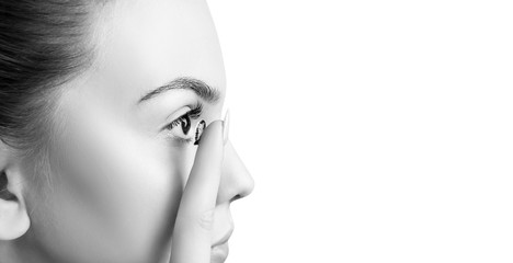 Side view on young woman wearing green contact lenses.