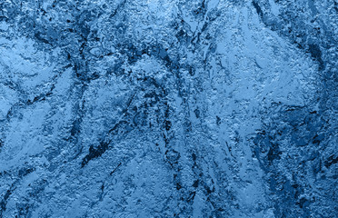 Abstract Grunge Decorative Relief Navy Blue Stucco Wall Texture. Wide Angle Rough Colored Background With spot light. Dark Background With Copy Space for design